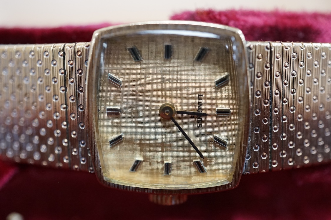 A lady's early 1970's 9ct gold Longines manual wind wrist watch, on an associated 9ct gold bracelet, gross weight 38 grams, with Longines box and pamphlet.